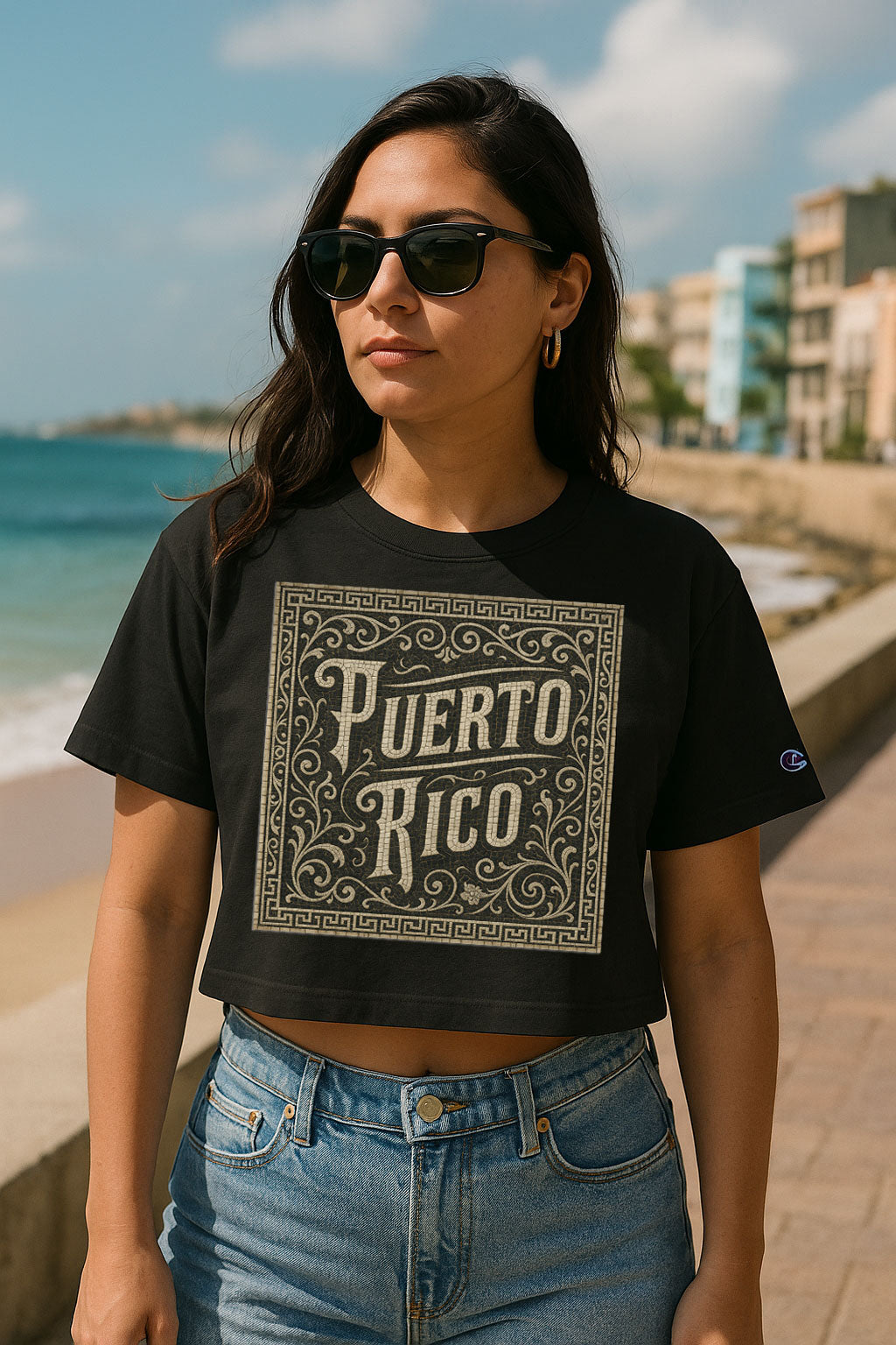 Woman wearing a black 'Puerto Rico' t-shirt on a beach.