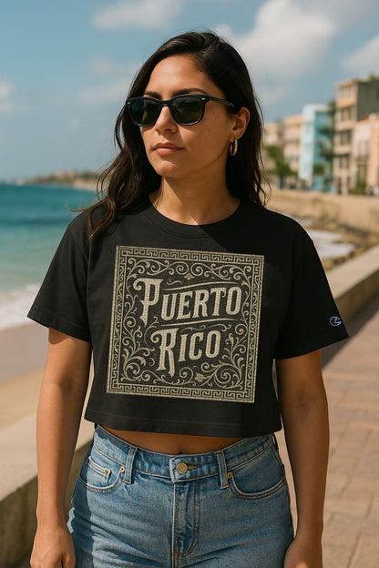 Woman wearing a black 'Puerto Rico' t-shirt on a beach.